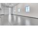 Large garage with finished floor, overhead door and natural lighting from multiple windows at 32278 N 168Th Ave, Surprise, AZ 85387