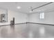 Clean and spacious garage with epoxy flooring, lighting, and ample room for storage and vehicles at 32278 N 168Th Ave, Surprise, AZ 85387