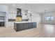 Spacious kitchen showcasing a large island, stylish lighting fixtures, and modern appliances at 32278 N 168Th Ave, Surprise, AZ 85387
