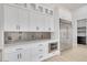 Close-up of modern kitchen featuring stainless steel appliances and white cabinets at 32278 N 168Th Ave, Surprise, AZ 85387
