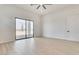 Bright living room boasts light wood flooring and sliding glass doors leading to the outdoor patio at 32278 N 168Th Ave, Surprise, AZ 85387