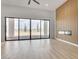 Bright living room with a modern fireplace, sleek flooring, and large sliding doors with outdoor access at 32278 N 168Th Ave, Surprise, AZ 85387