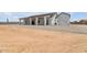 Rear exterior of home with a neutral color scheme, an extended patio and gravel landscaping at 32278 N 168Th Ave, Surprise, AZ 85387