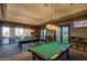 Game room with two billiard tables, comfortable seating, and a large screen TV at 16781 S 181St Ln, Goodyear, AZ 85338