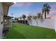 Lush green backyard with a block fence, mature trees, and a well-maintained lawn at 2236 E Blanche Dr, Phoenix, AZ 85022