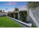 Private backyard featuring a lush lawn and a vibrant, colorful tiled planter at 2236 E Blanche Dr, Phoenix, AZ 85022