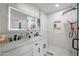 Modern bathroom features double sinks, white tile, a glass shower, and a lighted mirror at 2236 E Blanche Dr, Phoenix, AZ 85022