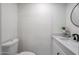 Modern half bathroom featuring sleek fixtures, white counter and vanity, and a round mirror at 2236 E Blanche Dr, Phoenix, AZ 85022