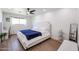 Bright primary bedroom featuring a plush bed, natural light, and wood-look floors at 2236 E Blanche Dr, Phoenix, AZ 85022