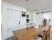 Bright dining area featuring a long wooden table with seating and a sliding barn door at 2236 E Blanche Dr, Phoenix, AZ 85022