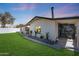 Exterior view of the home showcasing the backyard, covered patio, and landscaping at 2236 E Blanche Dr, Phoenix, AZ 85022