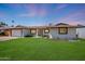 Single-story home boasts lush lawn, well-lit entryway, and a clean two-car garage at 2236 E Blanche Dr, Phoenix, AZ 85022