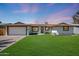 Well-maintained home with a lush green lawn, desert landscaping, and a welcoming front entrance at 2236 E Blanche Dr, Phoenix, AZ 85022