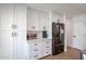 Kitchen features white cabinets, modern hardware, and stainless steel appliances at 2236 E Blanche Dr, Phoenix, AZ 85022