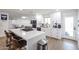 Modern white kitchen featuring an island with bar seating and stainless steel appliances at 2236 E Blanche Dr, Phoenix, AZ 85022