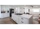 Modern kitchen features a large center island with a gas cooktop and stainless steel appliances at 2236 E Blanche Dr, Phoenix, AZ 85022