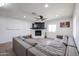 Inviting living room featuring a white brick fireplace, large tv, and neutral-toned sectional sofa at 2236 E Blanche Dr, Phoenix, AZ 85022