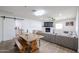 Open-concept living room and dining area with sleek floors and white brick fireplace at 2236 E Blanche Dr, Phoenix, AZ 85022