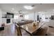 Open-concept living and dining area with a fireplace and modern kitchen in background at 2236 E Blanche Dr, Phoenix, AZ 85022
