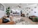 Open-concept living space with modern furnishings, a stylish rug, and a view of the kitchen at 2236 E Blanche Dr, Phoenix, AZ 85022