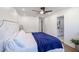 Bright main bedroom features a ceiling fan, ensuite bathroom, and neutral decor at 2236 E Blanche Dr, Phoenix, AZ 85022