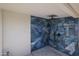 Custom shower featuring blue marble-like tile and sleek fixtures at 2236 E Blanche Dr, Phoenix, AZ 85022