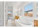 Bright bathroom boasts double sinks, a large soaking tub, and a window at 22886 E Alyssa Rd, Queen Creek, AZ 85142