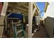 Backyard storage area with ladders, tools, and a bicycle at 6313 W Onyx Ave, Glendale, AZ 85302