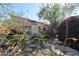 Exterior showcasing vibrant landscaping with flowers and shrubs surrounding the property at 6313 W Onyx Ave, Glendale, AZ 85302