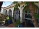 Arched front entrance featuring wrought iron decor and colorful potted plants at 6313 W Onyx Ave, Glendale, AZ 85302