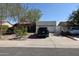 Charming single-story home with a well-manicured front yard, private gate, and a spacious driveway leading to a two-car garage at 6313 W Onyx Ave, Glendale, AZ 85302