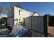 Side view of the garage with a gate and car in the foreground at 6313 W Onyx Ave, Glendale, AZ 85302