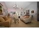 Well-lit living room with couches and a chandelier at 6313 W Onyx Ave, Glendale, AZ 85302