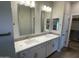 Double vanity bathroom with gray tile and modern lighting fixtures at 9987 W Verde Ln, Avondale, AZ 85392