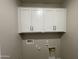 Laundry room with white cabinets and built-in shelving at 9987 W Verde Ln, Avondale, AZ 85392