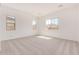 Neutral bedroom features plush carpet, bright windows and ample space for relaxation and personalization at 12015 W Parkway Ln, Avondale, AZ 85323