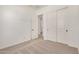 Carpeted bedroom featuring a closet and white doors, offering ample storage space at 12015 W Parkway Ln, Avondale, AZ 85323