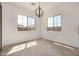 Sunlit dining room boasts tile floors, modern lighting, and expansive windows offering bright, natural light at 12015 W Parkway Ln, Avondale, AZ 85323