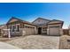 Beautiful home exterior featuring a spacious three car garage, paved driveway, and stone accents at 12015 W Parkway Ln, Avondale, AZ 85323