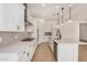 Well-lit kitchen featuring white cabinetry, stainless steel appliances, an island, and modern fixtures at 12015 W Parkway Ln, Avondale, AZ 85323