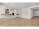 Bright and airy living room showcasing an open layout, seamlessly connected to a modern kitchen with a center island at 12015 W Parkway Ln, Avondale, AZ 85323