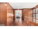 Elegant hallway with wood walls and floors, leading to a luxurious bedroom at 5676 E Cheney Dr, Paradise Valley, AZ 85253