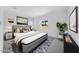 Serene bedroom featuring a plush bed, modern artwork, and a view of the neighborhood at 8722 W Denton Ln, Glendale, AZ 85305