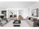 Open-concept living room with a view into the dining area, featuring neutral tones and modern decor at 8722 W Denton Ln, Glendale, AZ 85305
