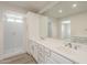 Bright bathroom with a double sink vanity, tiled shower and toilet, plus ample counter space and natural light at 18009 N 15Th Dr, Phoenix, AZ 85023