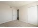 Cozy bedroom featuring neutral carpeting, a closet, and a door to another room at 18009 N 15Th Dr, Phoenix, AZ 85023