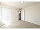 Comfortable bedroom featuring carpet, white trim and a closet for ample storage space at 18009 N 15Th Dr, Phoenix, AZ 85023