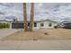 Charming single-story home featuring a well-maintained yard with desert landscaping and a two-car garage at 18009 N 15Th Dr, Phoenix, AZ 85023