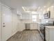 Modern kitchen with stainless steel appliances, white cabinets, and a skylight for natural lighting at 18009 N 15Th Dr, Phoenix, AZ 85023