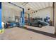 A large garage with two classic cars and car lifts at 12913 N 119Th St, Scottsdale, AZ 85259